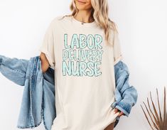 Show your pride as a Labor and Delivery nurse with this Comfort Colors Shirt, a perfect Delivery Nurse Tee for any L&D professional. An ideal gift for baby delivery nurses who bring new life into the world! #LDNurse #DeliveryNurseGift #LaborAndDeliveryShirt ♥PRODUCTION TIME: 1-5 days (usually 2-3 days) ♥SHIPPING TIME: 2-5 days (usually 3 days) ♥PRODUCT DESCRIPTION: Comfort Colors® 1717 T-Shirt Super soft cotton and excellent quality print makes. 100% ring-spun cotton (fiber content may vary for Labor Nurse Gift, L And D Nurse, Delivery Nurse Gifts, Labor Delivery Nursing, Baby Delivery, Labor Nurse, Labor And Delivery Nurse, Nurse Tshirt, Delivery Nurse