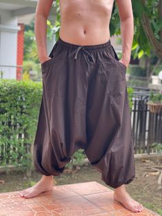 "Harem Pants Ethically Made in Thailand, Low crotch yoga pant, Unisex harem pants, Gorgeous Harem Pants, Lounge & Yoga Trousers Thai Cotton harem pants have the \"flow\", perfect for yoga or just a cool strolling. Comfort and character are what these pants are all about. They have the traditional sarong look & feel but a lot more practical when it comes to activities like yoga. As a bonus, they are convertible! Just pull them up and you get yourself a cute jumpsuit in a flash. Together with elas Baggy Yoga Pants With Drop Crotch, Brown Full Length Yoga Pants, Yoga Harem Pants With Pockets, Cotton Drop Crotch Harem Pants For Yoga, Stretch Harem Yoga Pants, Stretch Drop Crotch Harem Pants For Yoga, Harem Pants With Pockets For Meditation, Cotton Harem Yoga Pants, Baggy Parachute Pants For Yoga