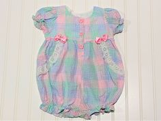 This is a beautiful blue pink and green gingham romper, sz 12 mo. Eyelet trim and bows detail the chest. Three flower button closure on the front. This romper would be perfect for Easter, Church or any special event. Anytime you want to show off your beautiful baby would be a time to wear this wonderful item. Made By: Metro Express Size: 12 months *email me if you need measurements Gingham Romper, Vintage Pajamas, Vintage Baby Clothes, Pink Blanket, Flower Button, Green Gingham, Little Dresses, Baby Romper