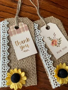 two tags with sunflowers on them are hanging from twine string and have thank you tags attached to them