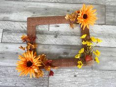 the letter f is made out of wood and decorated with sunflowers