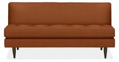 a brown couch sitting on top of a white floor