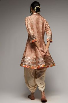 Editor's Note Indulge in the elegance of the tilla kurta and dhoti set, intricately embroidered with zardosi work and adorned with a strong floral butta and geometric jaal. Delicately enhanced with tiny motifs in silver foil, the ensemble exudes a subtle shimmer and richness. Gota motifs scattered all over accentuate the neckline, adding to its charm. Fabric: Kurta: tussar silk, dhoti: cotton Color: Pink Component: Kurta and dhoti Occasion: Festive Note: Product colour may slightly vary due to p Pink Kurta, Zardosi Work, Indian Arts And Crafts, Personal Shopping Service, Silver Foil, Indian Design, Handmade Clothes, Personal Shopping, Personal Stylist