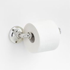 a close up of a toilet paper holder on a white wall with a roll of toilet paper in it