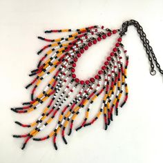 The strands are made of red, dark green, yellow, gold and white seed beads.  They are separated by coral beads.   The necklace is finished with a bronze chain and hook closure.  The finished length is about 18.5", I can adjust the length if you wish. The longest fringes are about 5" long. Coral Beads Necklace, Long Fringes, Cow Girl, Coral Beads, Dark Green, Seed Beads, Coral, Beaded Necklace, Handmade Jewelry