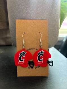 I'm a proud UC alum and have two son's currently attending the University of Cincinnati College of Business so I have to represent my Bearcats with these fun C claw football helmet earrings.  These are 3D printed to be lightweight and feature a hypoallergenic, nickel free earring hook.  These would be perfect to wear to any UC football game, graduation ceremony or just to show your Bearcat pride! The charm measures approximately 1.5 inches long.   Earring hooks are available in silver, gold or b Long Earring, University Of Cincinnati, Earring Hook, Football Helmet, Nickel Free Earrings, Graduation Ceremony, Football Game, Football Helmets, Cincinnati