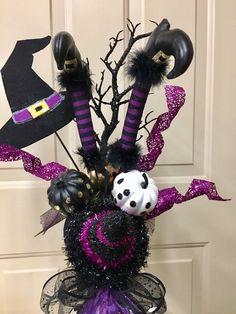 a vase filled with halloween decorations on top of a table