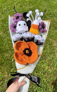 a bouquet of crocheted stuffed animals on top of a white paper towel in the grass