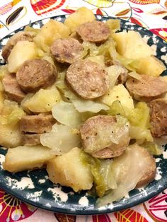 a bowl filled with meat and potatoes on top of a table