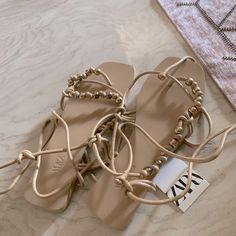 Beige Zara Sandals Brand New Chic T-strap Sandals With Ankle Strap For Beach, Chic Ankle Strap T-strap Sandals For Beach, Chic Ankle-strap T-strap Sandals For Beach, Chic Open Toe Lace-up Sandals For Beach Season, Party Lace-up Open Toe Sandals For Beach Season, Chic Ankle Strap Toe Ring Sandals For Spring, Beige Sandals For Party And Beach Season, Beige Open Heel Lace-up Beach Sandals, Chic Flat Heel Lace-up Sandals For Beach