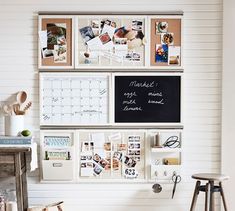 a white wall with pictures and magnets on it, next to a small stool