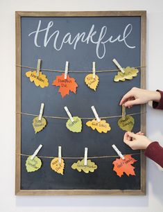 a chalk board with clothes pins attached to it and the words thank written on them