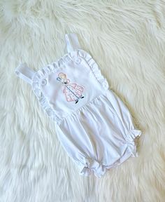 This listing is for a sun suit. This adorable embroidered Bo Peep sun suit will look adorable on your little girl.  I can also change the colors. If you are looking for a certain color scheme just let me know. I am happy to change it to meet your needs. Thanks so much for stopping by my shop Vacation Cotton Bubble Romper With Ruffles, Cotton Bubble Romper With Ruffles For Vacation, Summer Cotton Onesie With Ruffles, Playful Cotton Onesie For Vacation, White Summer Bubble Romper For Playtime, Fitted Cotton Onesie For Beach, White Onesie For Spring Vacation, Cute Onesie For Spring Vacation, White Ruffled Onesie For Playwear