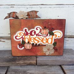 a wooden sign with some pumpkins on it