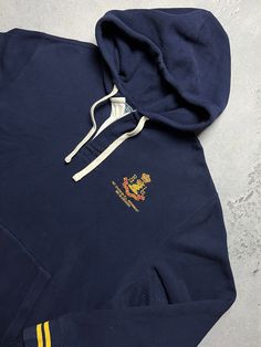 Polo Ralph Lauren 1st Division Logo Vintage Hoodie y2k 90s Size Men's / US XL / EU 56 / 4 Color Navy Condition Gently Used Vintage 2000s/Early 2010s Polo Ralph Lauren 1st Division RL Regiment 381 Blecker Hoodie Has rugby style collar and buttons The material is pleasant to the body. In a good condition. Fast sending! Condition : 8,7/10 Chest - 66 cm Length - 70 cm Shoulders - 55 cm Sleeve Length - 65 cm - ALL ITEMS ARE HEAT TREATED AND WASHED BEFORE SHIPPING - FOLLOW MY STORE - SEE MY OTHER ITEM Vintage Ralph Lauren Sweatshirt, Navy Hoodie With Embroidered Logo, Navy Long Sleeve Hoodie With Embroidered Logo, Navy Casual Hoodie With Embroidered Logo, Navy Sweatshirt With Kangaroo Pocket For Streetwear, Navy Hoodie Sweatshirt With Embroidered Logo, Navy Embroidered Logo Hooded Sweatshirt, Navy Hooded Sweatshirt With Embroidered Logo, Vintage Hoodie With Kangaroo Pocket