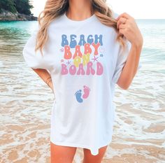 Sun, sand, and a little surprise: our Beach Baby On Board tee makes the perfect pregnancy reveal! 🌊👶 White Family Matching T-shirt For Beach, White Casual Maternity T-shirt, Family Matching White Maternity T-shirt, White Family Matching Maternity T-shirt, Cute White T-shirt For Gender Reveal, White Graphic Maternity T-shirt, Casual White Maternity T-shirt, Bump Friendly White Short Sleeve T-shirt, Family Matching White T-shirt For Beach