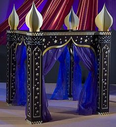 an elaborately decorated table with blue curtains