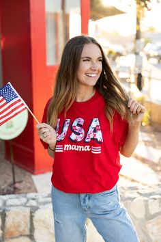 Show your love for the USA with our comfy USA Mama tee!! Whether you are celebrating the Fourth Of July or running errands this is the perfect tee for all the moms!! Please note that our TSL tees run about 1/2 a size smaller than our Jadelynn Brooke tees. *Model is wearing a medium* 100% cotton Measurements By Size Small 2/4 Medium 6/8 Large 10/12 XL 14/16 XXL 18/20 Mom mother madre mum mommy ma momma patriotism motherhood stars and stripes flag america us freedom proud red, white and blue Red Graphic Tee With American Flag Print, Red American Flag Graphic Tee, Red American Flag Print Graphic Tee, Casual Red T-shirt For 4th Of July, Red Casual T-shirt With American Flag Print, Red Slogan T-shirt For Spring, Red Relaxed Fit T-shirt For 4th Of July, Patriotic Red T-shirt With Letter Print, Mother's Day Red Graphic Print T-shirt