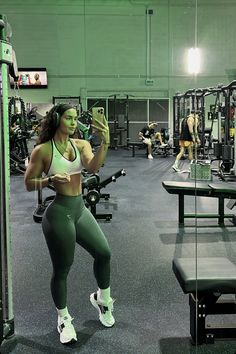 a woman is doing squats in the gym