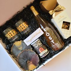 an open gift box filled with liquor and other items