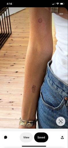 a woman's arm with two small tattoos on her left arm, and the other half