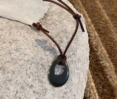 Handcrafted leather cord choker necklace with gemstone pendant Width: 2mm leather cord Color: black or brown leatherPendant: Hemalyke donut (man-made stone) - Donut size: 25x20mm Length: adjustable The sliding knot adjusting system enables necklace to adjust to any length from 14 to 30 inches. Hemalyke is a man-made stone with shiny, metallic grey look, pendants may have little scratches or dots representing the natural hematite. Cord Choker, Leather Corded Necklace, Sliding Knot, Handcrafted Leather, Cord Necklace, Leather Necklace, Leather Cord, Stone Necklace, Gemstone Pendant