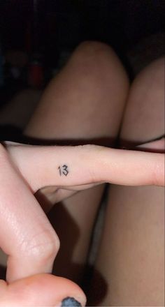 a person with a small tattoo on their finger