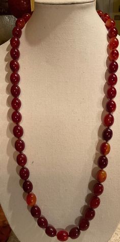 Up for Sale is this Beautiful DECO Cherry Amber Bakelite Necklace. This is a Beauty. It is in near Mint Condition. It measures 18" long. And weighs at 136 Grams. The entire necklace is Hand-Knotted. Plus there is no Clasp, as the necklace fits over the Head. Please See Photos. Classic Red Hand-strung Necklaces, Formal Single Strand Amber Necklace, Formal Amber Single Strand Necklace, Amber Single Strand Necklace For Formal Occasions, Formal Oval Necklace With Polished Beads, Classic Formal Necklace With Oval Beads, Formal Single Strand Necklace With Oval Beads, Classic Oval Bead Necklace For Formal Occasions, Bakelite Necklace