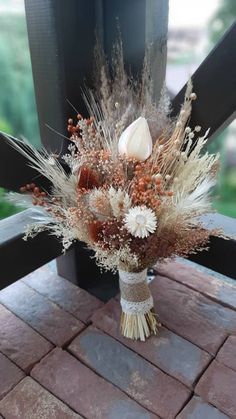 a bouquet of flowers sitting on top of a wooden bench