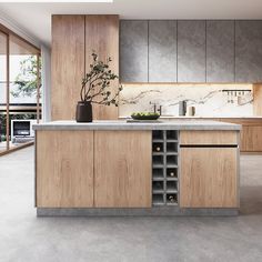 a modern kitchen with wooden cabinets and marble counter tops, along with an island in the middle