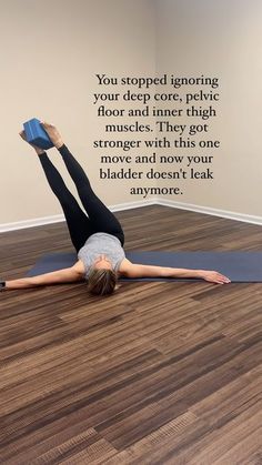 a woman is doing yoga on the floor with her feet up and arms in the air