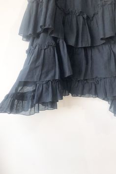 Hache Black Tiered Ruffle Skirt. Great condition. Solid black tiered and ruffle knee length skirt with slight handkerchief hem. Has elastic at waist band for easy pull on. 100% Cotton. Marked as size 42. Made in italy. Approx. Measurements: Underarm to Underarm: 16 1/2" laid flat Length: 23" at center and 29" at sides Flowy Asymmetrical Skirt Dress With Ruffle Hem, Asymmetrical Skirt Dress With Ruffle Hem And Flowy Fit, Tiered Flowy Skirt With Ruffle Hem, Chic Tiered Skirt With Layered Hem, Chic Layered Tiered Skirt, Chic Tiered Dress With Relaxed Skirt, Black Skirted Dress With Ruffles, Tiered Skirt With Ruffle Hem, Black Tiered Gathered Skirt