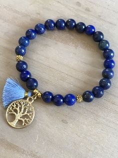 This beautiful bracelet is made of 8mm lapis lazuli beads, gold spacers and it is adorned with a tree of life pendant and a mini tassel 20mm. The bracelet shown fits to 7.75 inches wrist but you can choose your own wrist size. Lapis Lazuli *third eye and throat chakra *stimulates wisdom and good judgement *activates the higher mind and enhances intellectual ability *enhances the desire for knowledge, truth and understanding *is a stone of truth that deepens communication with calmness and loving Bohemian Lapis Lazuli Bracelet As A Gift, Bohemian Lapis Lazuli Bracelet For Gift, Bohemian Lapis Lazuli Beaded Bracelets, Bohemian Lapis Lazuli Beaded Bracelets As Gift, Spiritual Bracelets, Tree Of Life Bracelet, Lapis Lazuli Bracelet, Lapis Lazuli Beads, Tassel Bracelet