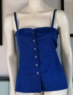 "80s Beautiful Yves Saint Laurent Rive Gauche 100% cotton top in the typical YSL blue Closes with 6 buttons on the front Unlined Made in France Size : 38FR US6 UK10 Chest : 80cm 31 1/2\" Belt : 80cm 31 1/2\" Length : 42cm 16 1/2\" Bustier bottom 45 cm 17 3/4\" In excellent condition. Seems to have never been worn" Blue Summer Tops With Snap Buttons, Blue Tops With Snap Buttons For Summer, Fitted Blue Tops With Snap Buttons, Blue Retro Tops With Buttons, Vintage Sleeveless Tops With Button Closure, Vintage Sleeveless Buttoned Tops, Vintage Blue Sleeveless Top, Ysl Clothing, Ysl Clothes