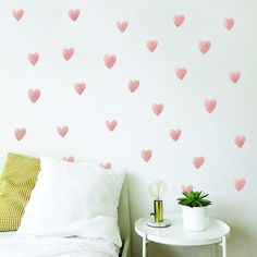 a bedroom with pink hearts on the wall