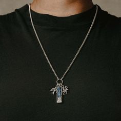 This nautical charm pendant is inspired by military dog tags, and is named after the response given to a command from a ranking officer. The tag itself is flanked by a swallow and an octopus, and is inlaid with a shimmering blue Lapis stone, representing the vast expanse of the seven seas. The tag also features detailed wave engravings on the back. Comes on a 60cm x 3mm stainless steel rounded box chain with custom sterling silver bone clasp. Each stone is unique and will vary from what is pictu Sterling Silver Dog Tag Necklace With Charms, Clocks And Colours, Military Dog, Dog Tags Military, Lapis Stone, Aye Aye, Seven Seas, Blue Lapis, The Seven