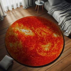 a large sun rug is on the floor next to a bed