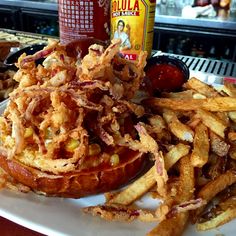 a plate topped with french fries next to a can of soda and hot dog buns