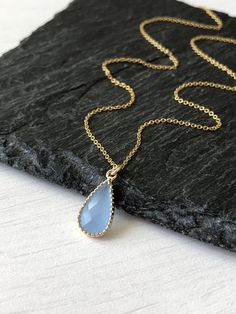 Blue Chalcedony Necklace, Cobalt Teardrop Pendant, Minimalist Blue Gold Drop Necklace, Dainty Layering Jewelry, Delicate necklace for women This simple dainty necklace features an soft cobalt blue chalcedony teardrop set in texturized bezel in gold filled. This framed stone pendant is suspended from a delicate 14k gold filled chain. This necklace is simply perfect for everyday wear and is perfect for layering with other pieces in your collection. About this Necklace: - Gemstone: Cobalt Chalcedon Minimalist Blue Teardrop Pendant Jewelry, Blue Drop Necklace For Gift, Dainty Blue Drop Jewelry, Blue Drop Necklaces For Gifts, Elegant Blue Teardrop Crystal Necklace, Blue Teardrop Pendant Minimalist Jewelry, Blue Minimalist Teardrop Pendant Jewelry, Blue Teardrop Pendant Necklace With Adjustable Chain, Blue Teardrop Necklace With Adjustable Chain