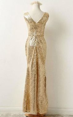 a dress on a mannequin with gold sequins and an open back