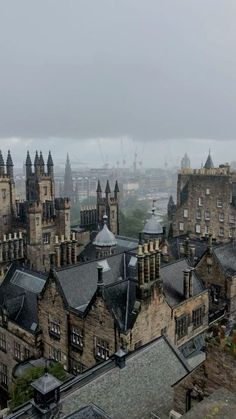 an aerial view of old buildings and spires on a cloudy day in the city