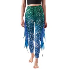 a woman wearing blue and green mermaid tail leggings with fish scales on it