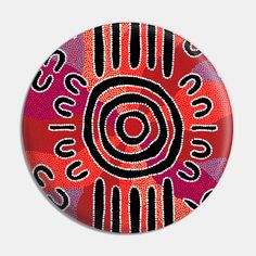 a red and black abstract design on a button