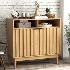 a wooden cabinet sitting in front of a white brick wall