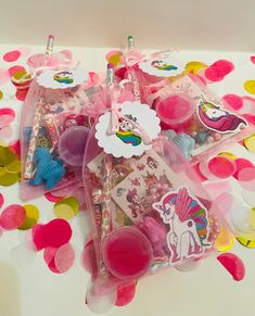 some pink and yellow confetti bags on a table