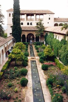 an outdoor garden with water running through it