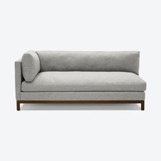 a gray couch sitting on top of a white floor