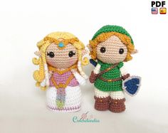 two crocheted figurines are standing next to each other on a white surface