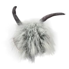 an animal's head is shown with long, furry hair and horns on it