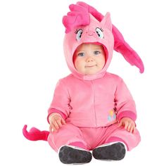 a baby in a pink costume sitting on the floor with its eyes closed and ears wide open